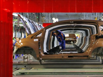 A worker checks vehicles at a Ford car plant in Craiova